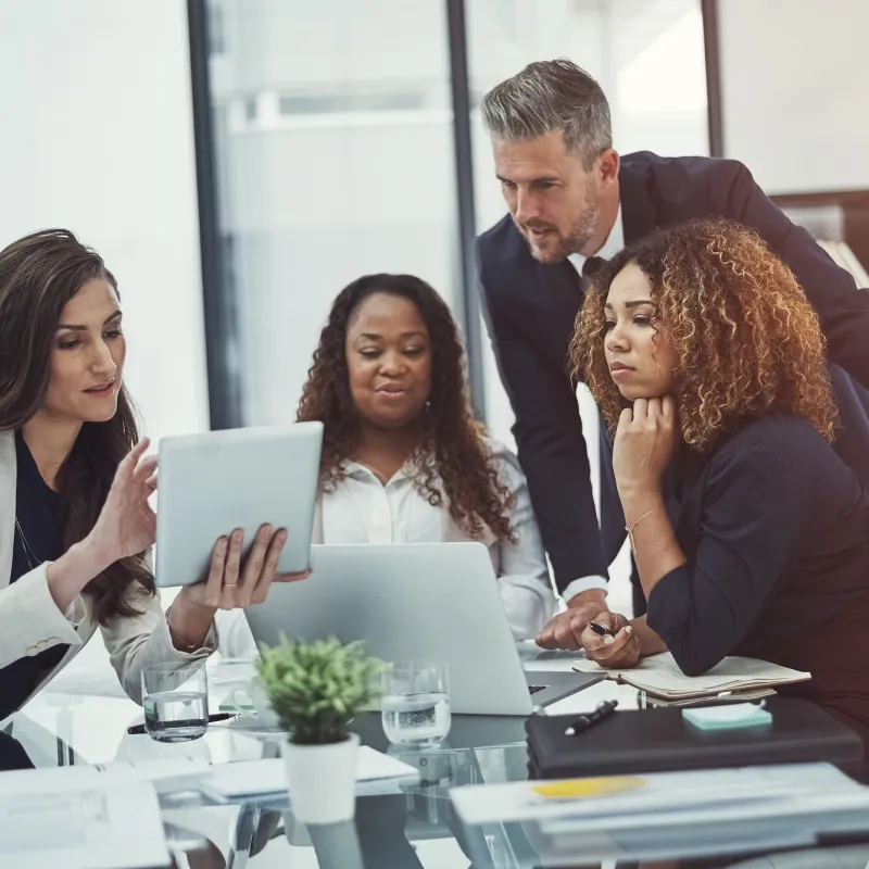 A group of co-workers engaged in a collaboration meeting