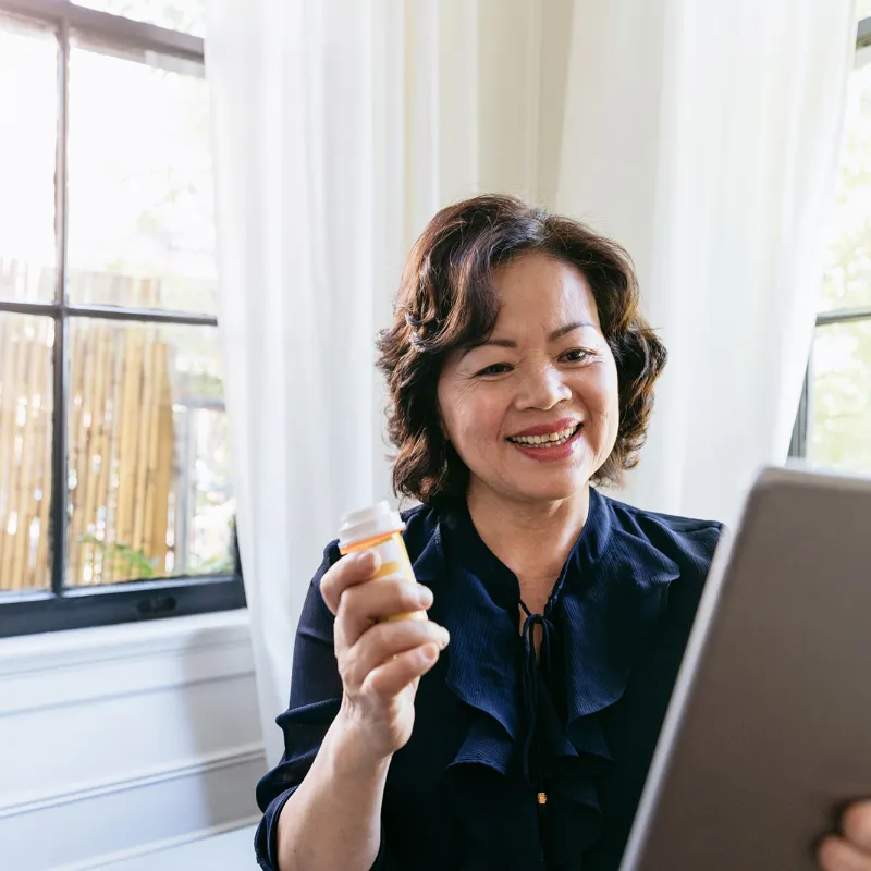 Woman showing her doctor her medication on a tablet.