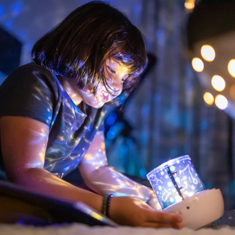 Child holding light projector