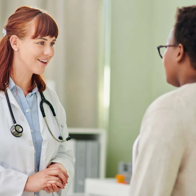 Female doctor talks with female patient