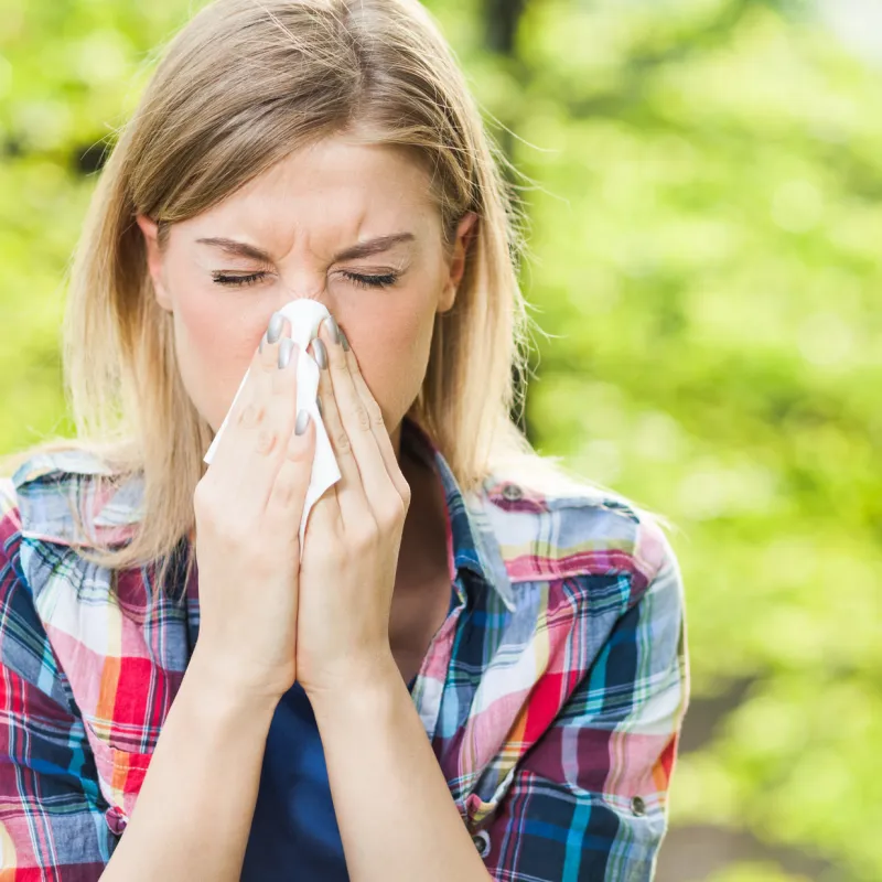 Woman Sneezing Outdoors