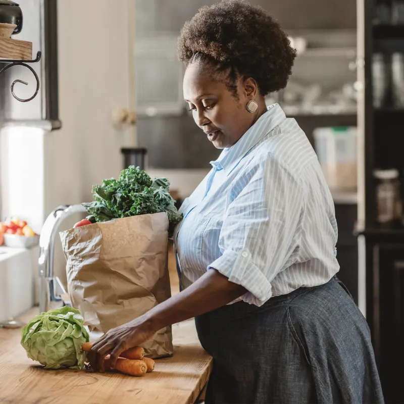 A woman unpacking her groceries. 