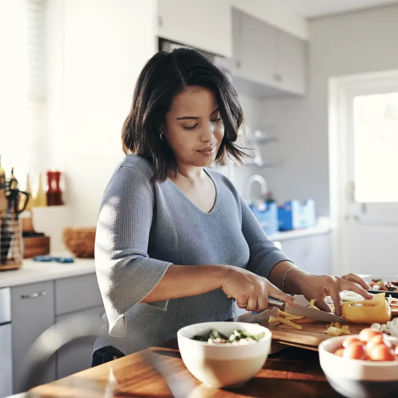 A woman preparing a healthy meal. 