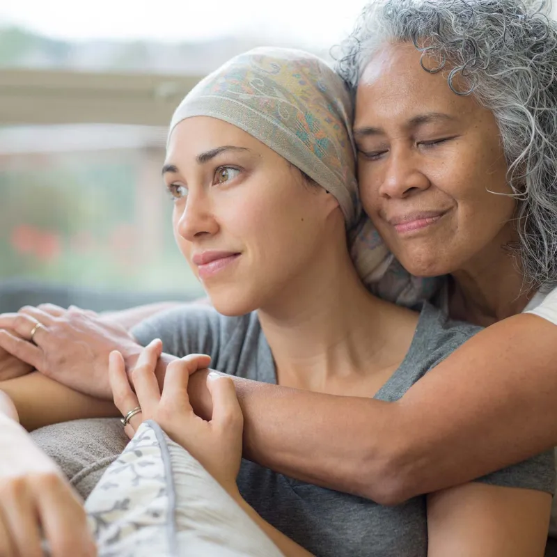 A senior mother hugging her mature daughter