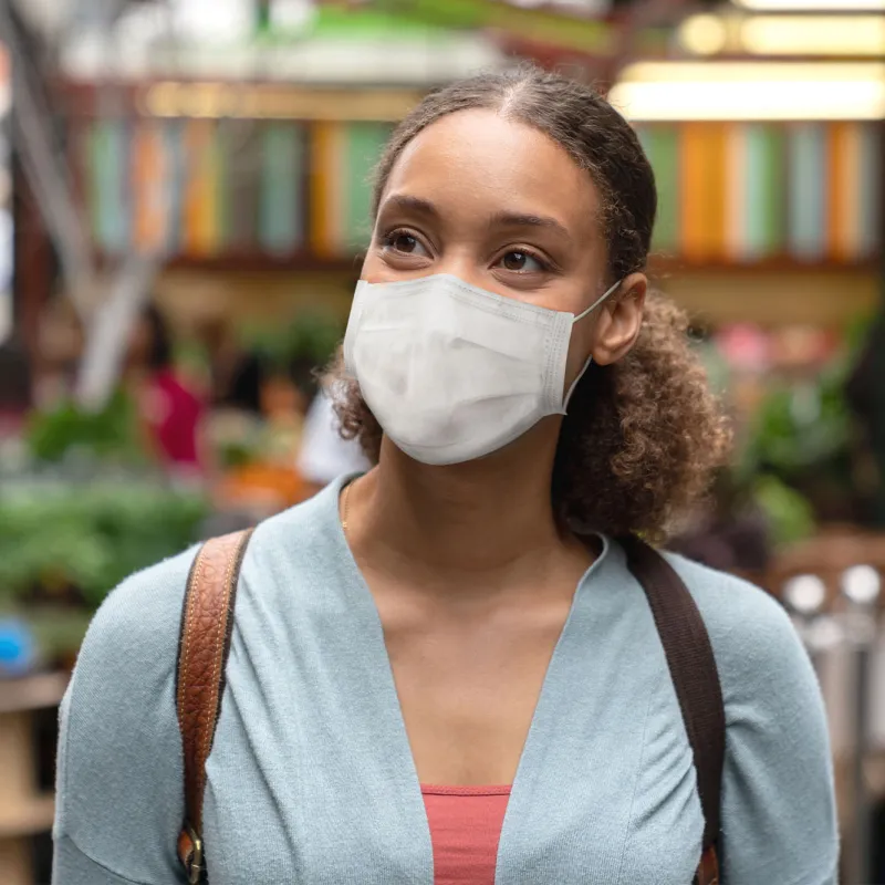 A woman wearing a mask in public.