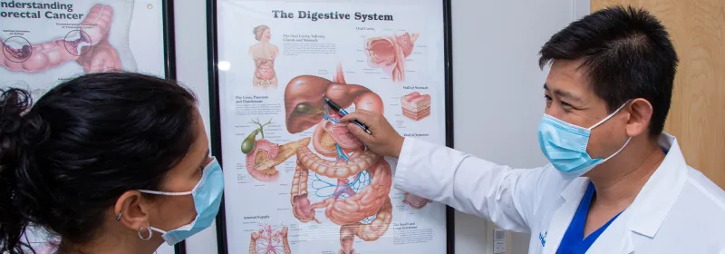 Dr. Iswanto Sucandy Showing patient diagram while wearing masks.