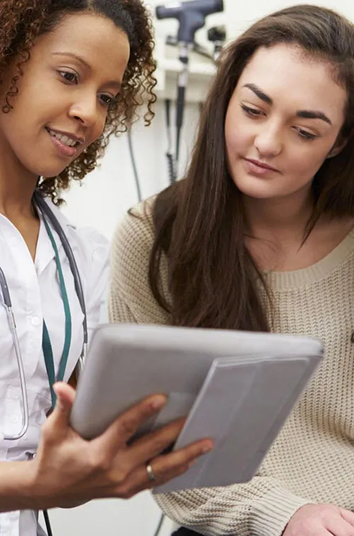 A young woman consults with her physician.