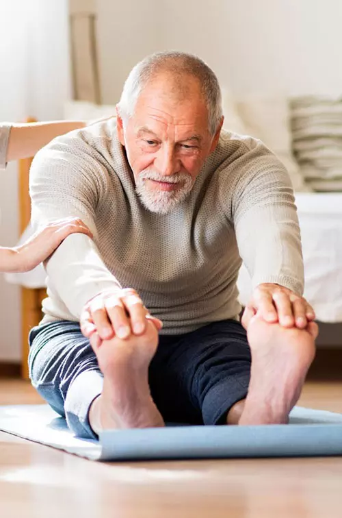 Man doing physical therapy at home