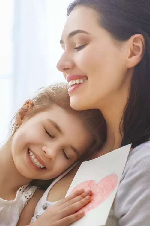 Mother and daughter share a loving hug