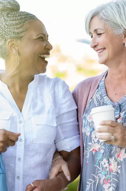 Two women walking and talking about their health.