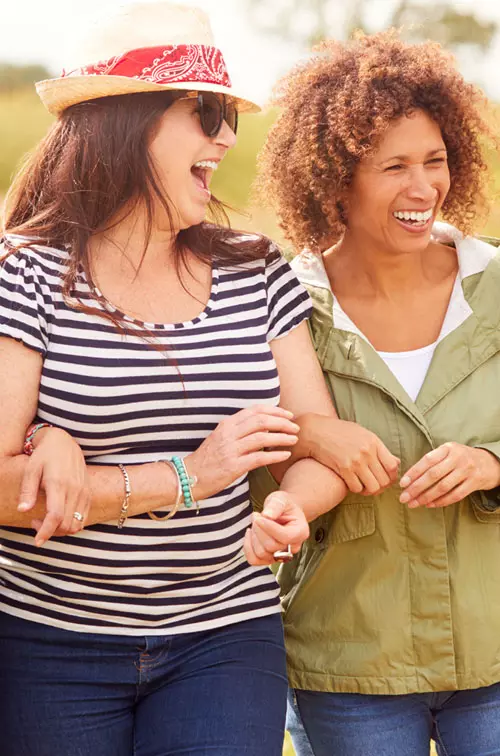 Woman walking and laughing outdoors