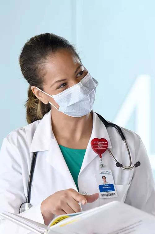 Two doctors talking while wearing masks.