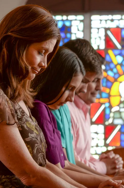 Family praying at church