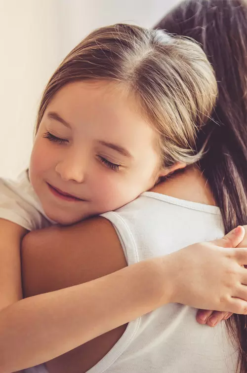 Young child embracing her mother