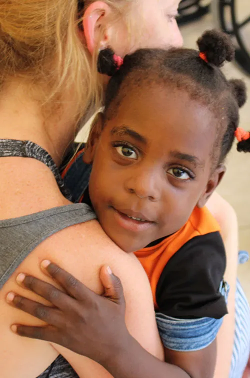 Woman holding a small child.