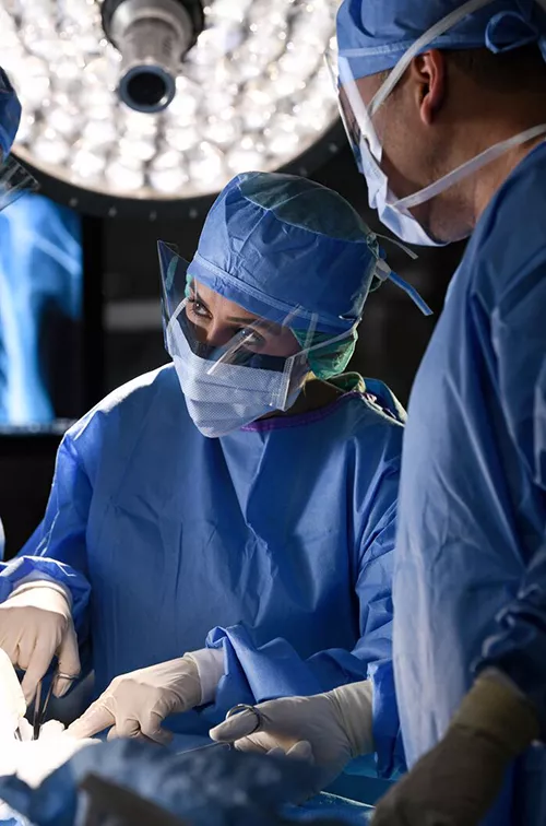 Surgeons in an operating room performing surgery.