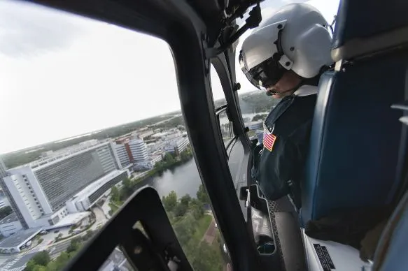 1. Todd Collette, RRT, scans the approach to AdventHealth Orlando as a Flight 1 helicopter brings a mock patient to the emergency room.