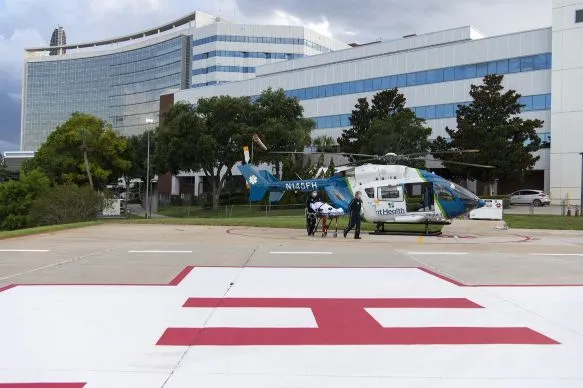 Flight 1 lands at the helipad at AdventHealth Orlando and a mock patient is transported to the ER by Todd Collette, RRT, and Skye Vriesenga, RN.