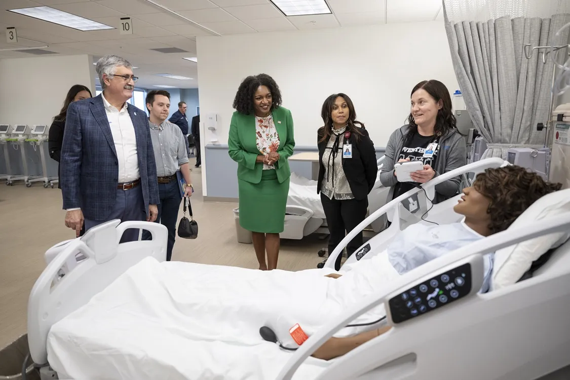 AdventHealth University faculty show a state-of-the-art manikin to C. Josef Ghosn, president of AdventHealth University, and Florida Rep. Fentrice Driskell.