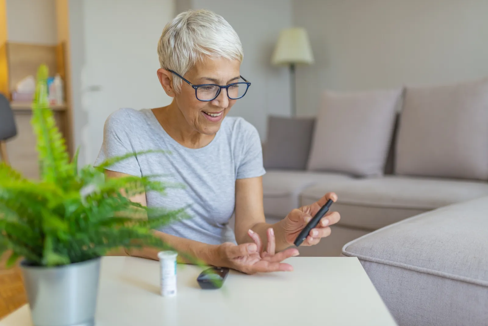 Older caucasion woman checking blood glucose