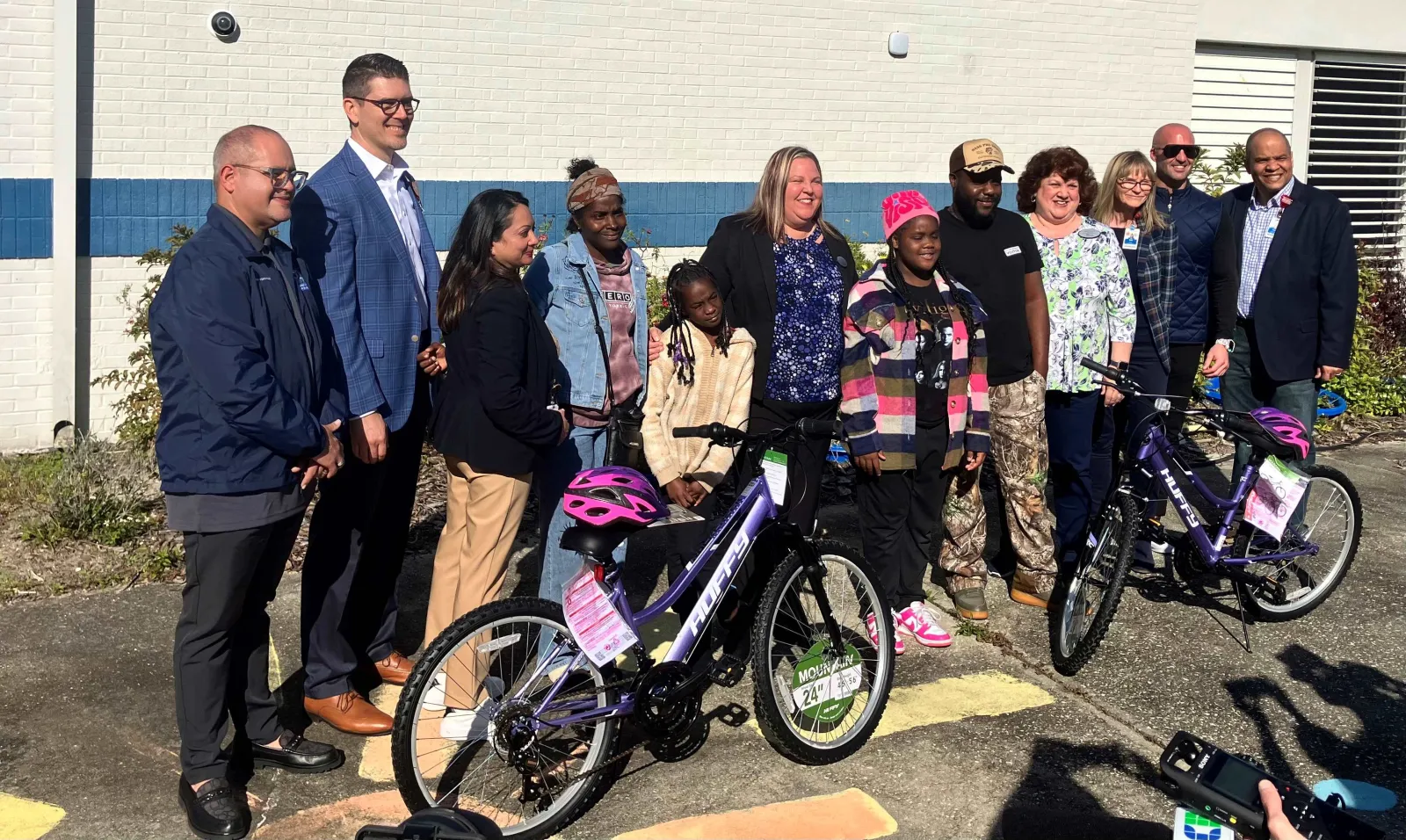 AdventHealth and Volusia County Schools leaders present free bikes to first of nearly 170 students.