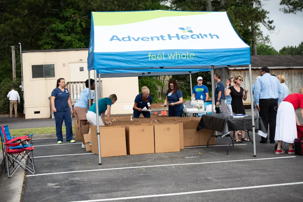 Teams gather to distribute food to cancer patients.