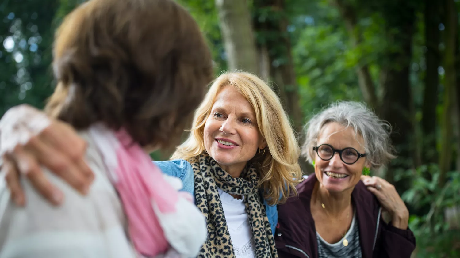 middle age women arms around each other