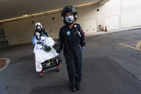 Flight 1 EMS workers transport a mock patient to AdventHealth East Orlando.