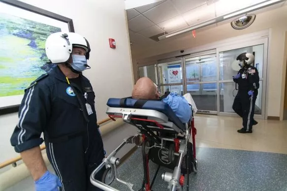 A mock patient arrives with Flight 1 EMS workers at an AdventHealth ER.