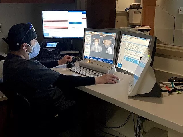 AdventHealth ER nurse checks the screens during a CT scan for stroke patient.