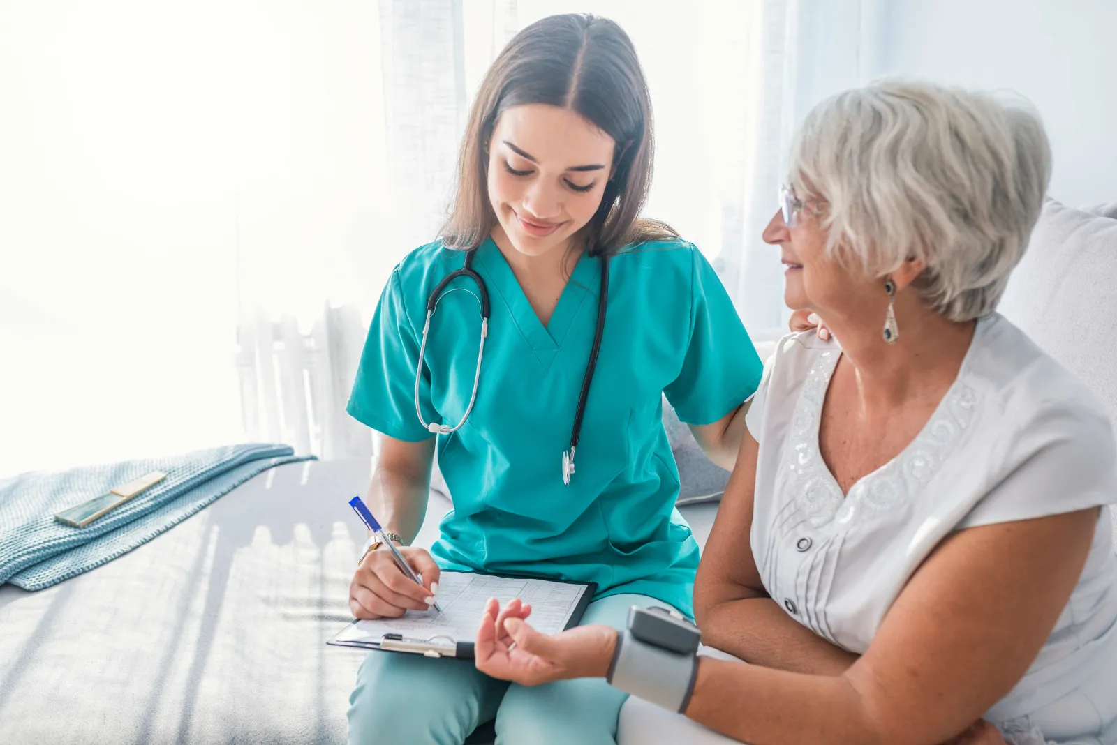 Nurse checking patients blood pressure.