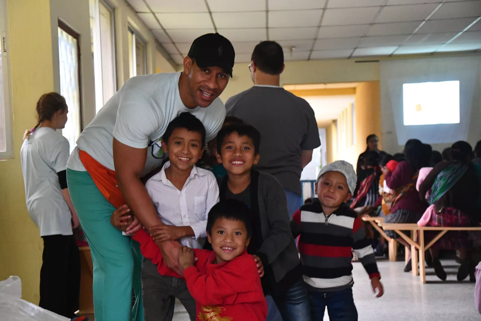 AdventHealth DeLand CEO Lorenzo Brown poses for the camera alongside several Guatemalan children.