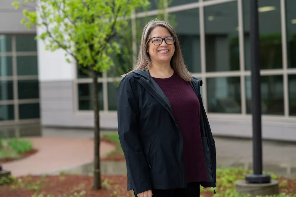 Woman stands in front of breast center