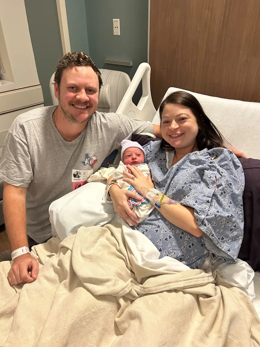 Parents with their new baby who was born during Hurricane Milton.