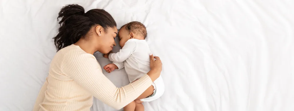 new mom cuddles with her newborn baby