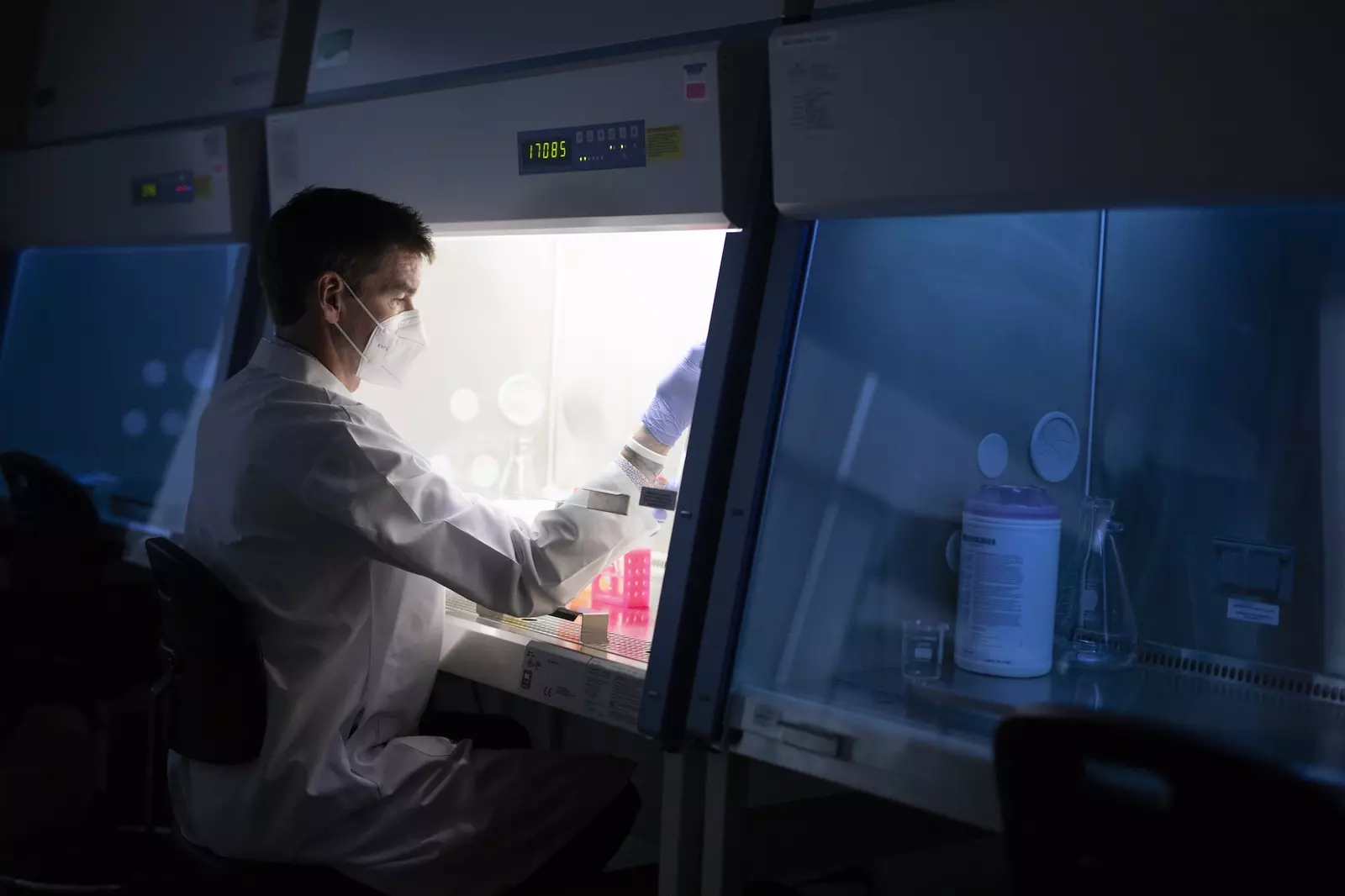 Masked Man doing scientific work in a lab