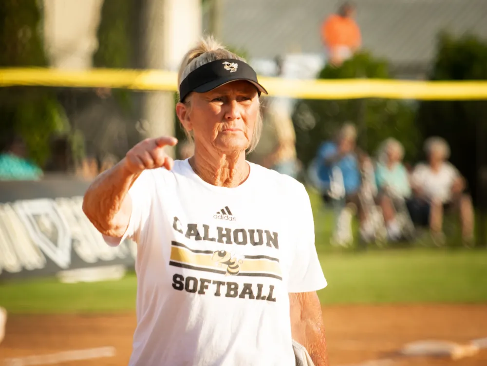 Coach Diane Smith coaches her athletes on the softball field.