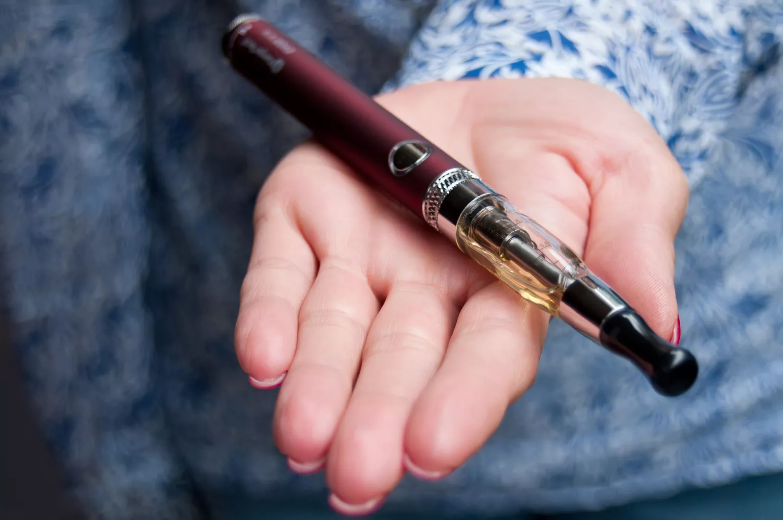 A woman holding an e-cigarette