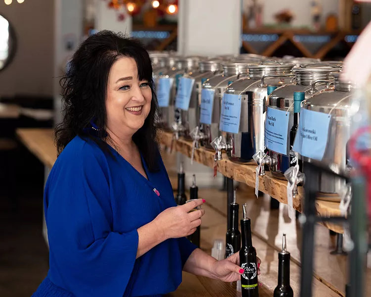 Sherri Hendrix pours olive oil for a taste test