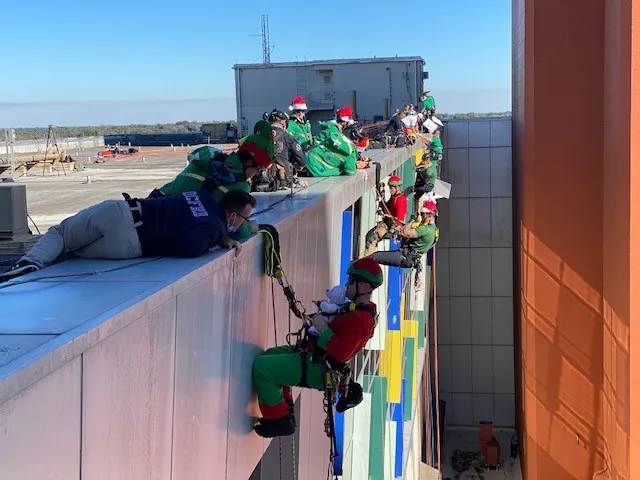 Orlando and Orange County fire rescue members rappel down AdventHealth for Children to surprise pediatric patients.