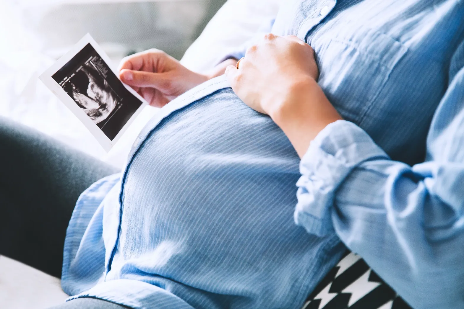 Pregnant woman looking at a picture.