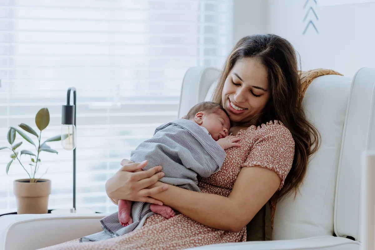 mother cuddles with new baby