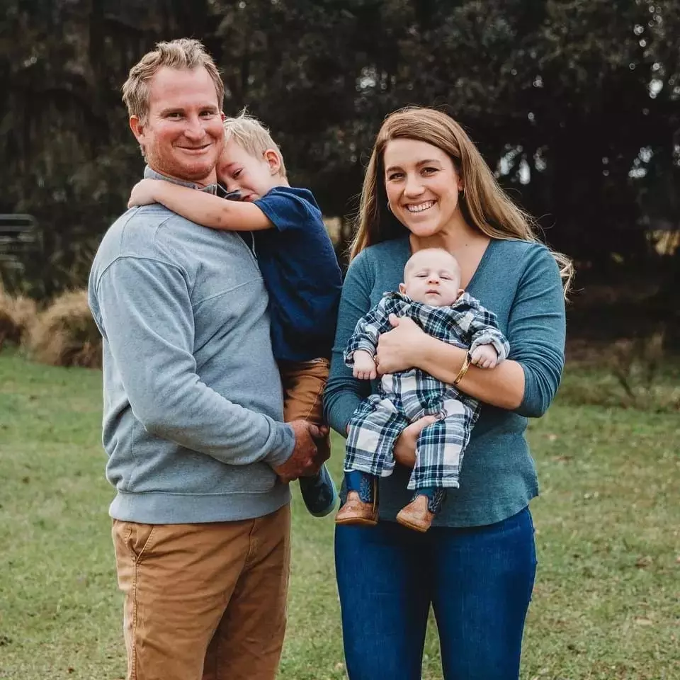 Corbett Family standing outside in a field.