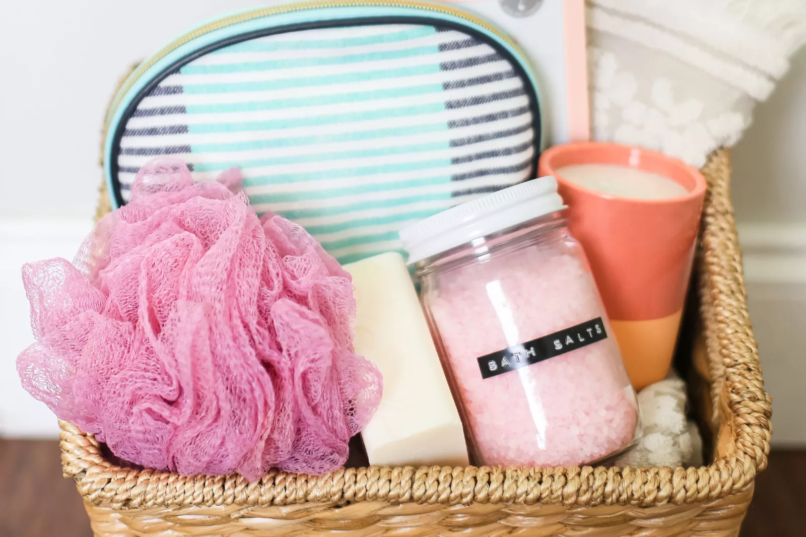 Gift basket with a candle, bath salts, and various bath products.