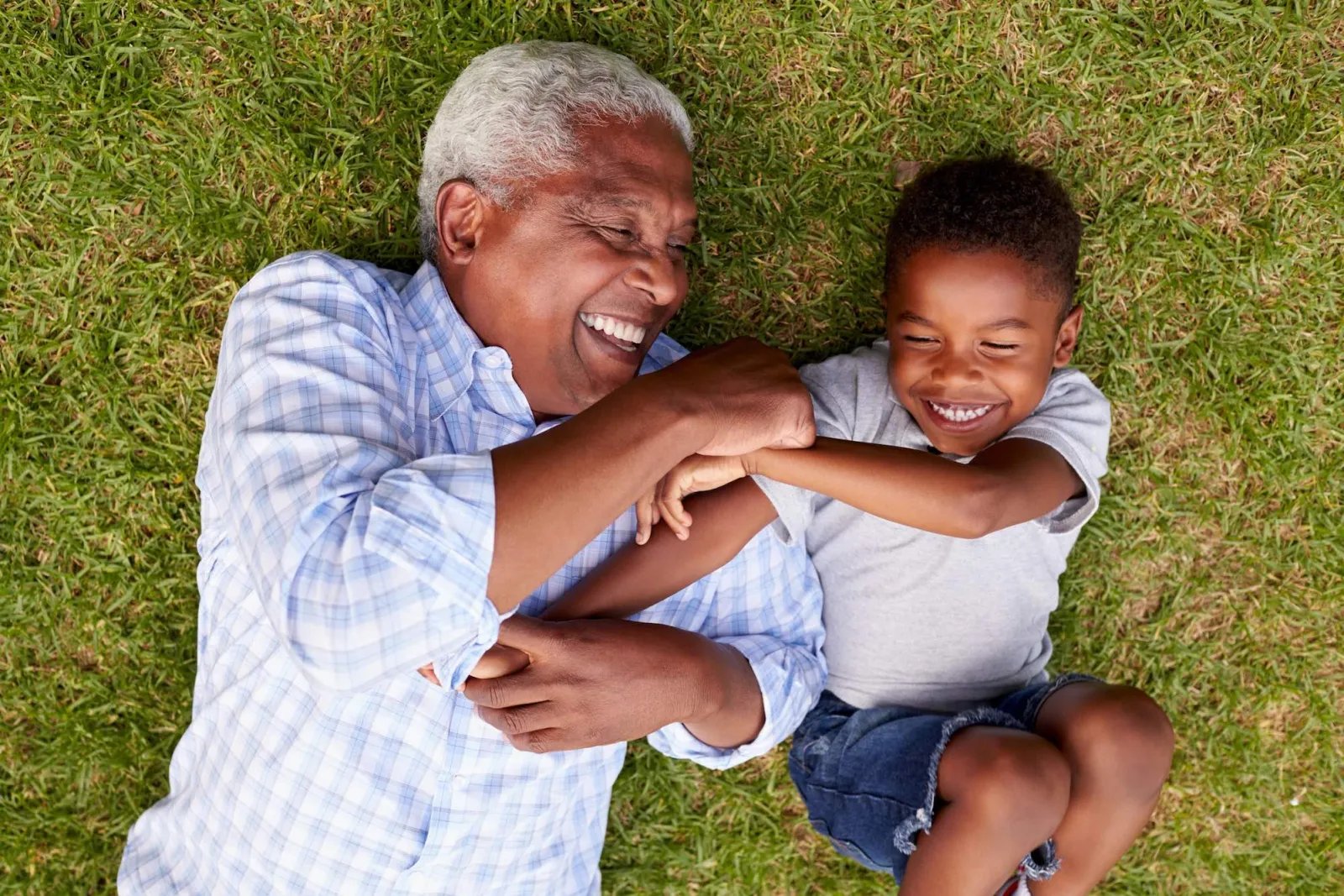 Grandfather playing with young grandson. 