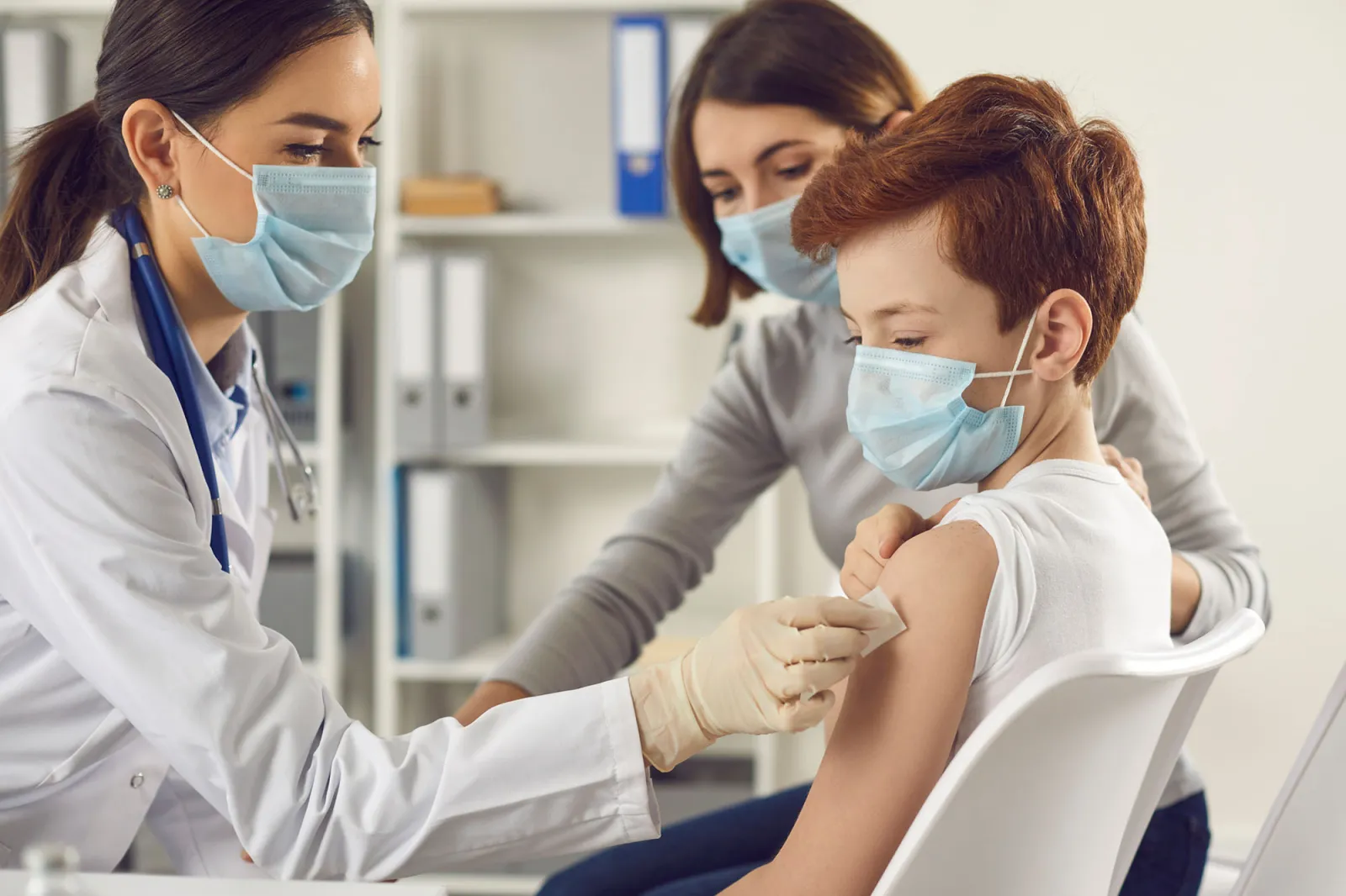 A young boy getting ready to receive a vaccine shot