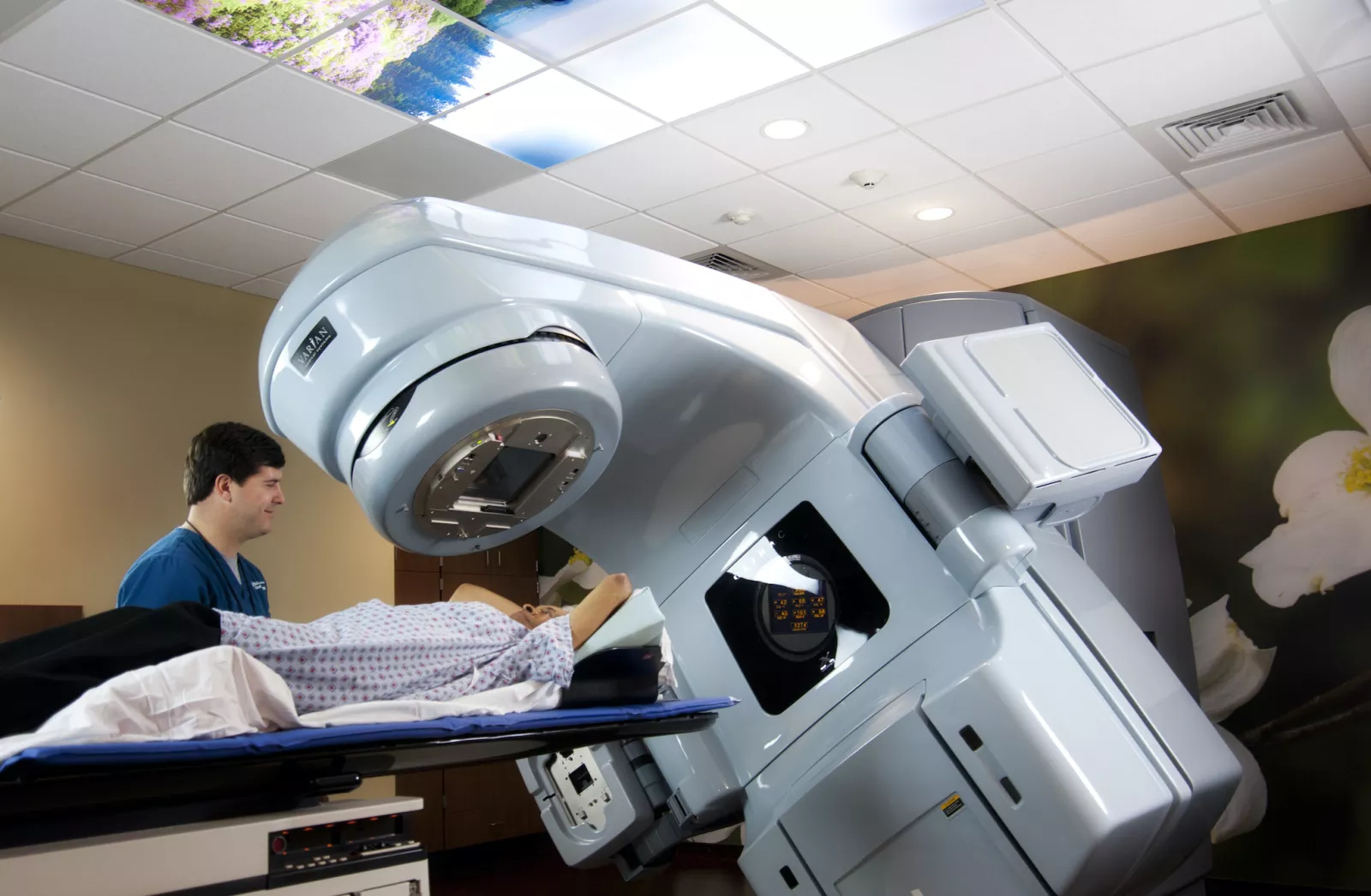 A technician uses an linear accelerator on a patient.