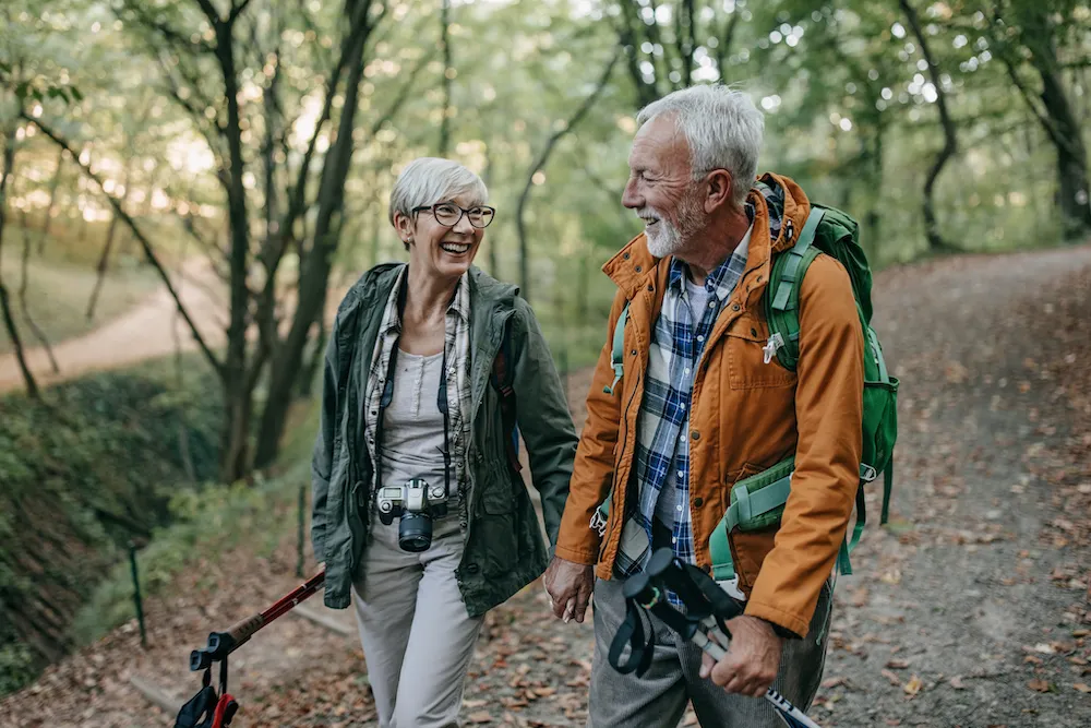 couple walks through the woods with healthy lungs