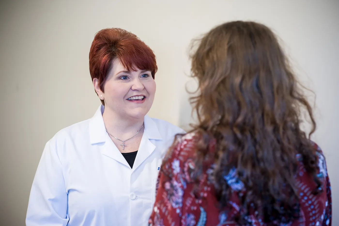 M. Lynn Herring speaks with a patient about her health.