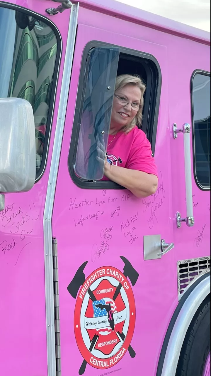 a photo of Mary Poillion in a pink firetruck